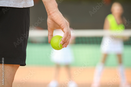 Young man playing tennis on court, closeup © Pixel-Shot