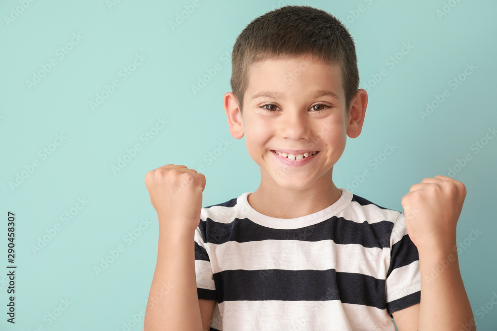 Portrait of happy little boy on color background - obrazy, fototapety, plakaty 