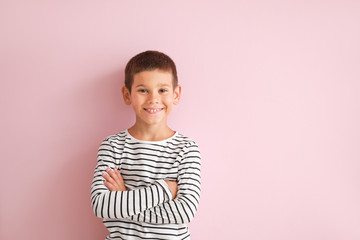 Portrait of happy little boy on color background