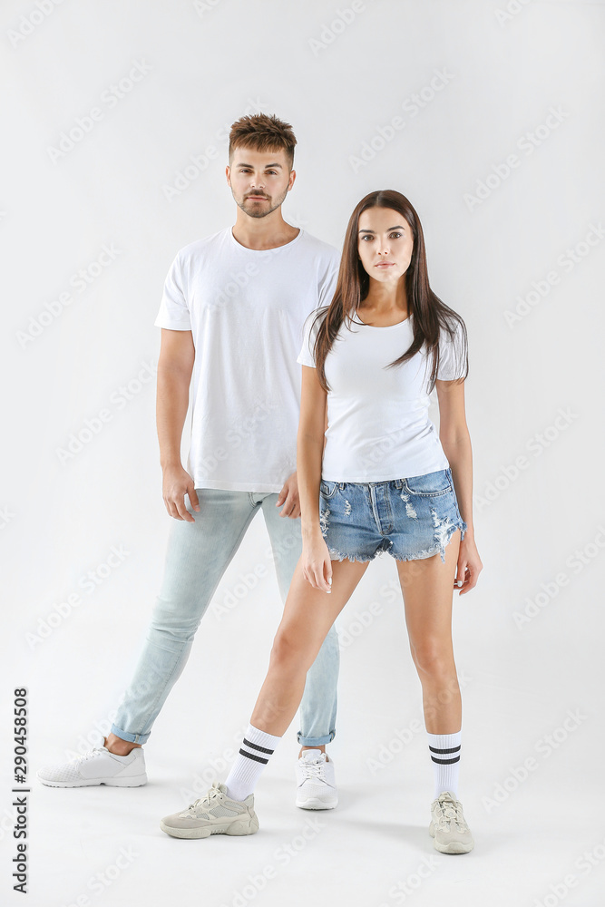 Fashionable young couple on white background Fashionable young couple on white background