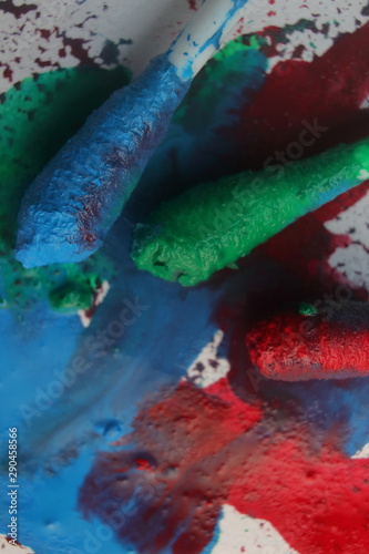 Cotton buds dipped in poster color. The background is full of red, green and bule colors.