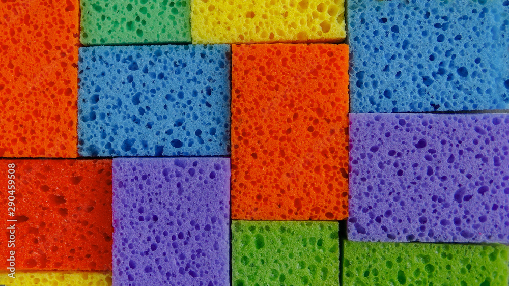Cleaning day concept, colorful sponges background