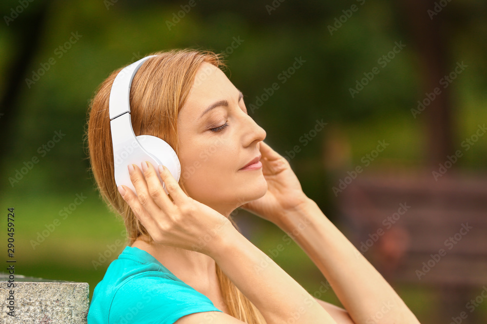 Woman with headphones listening to music outdoors