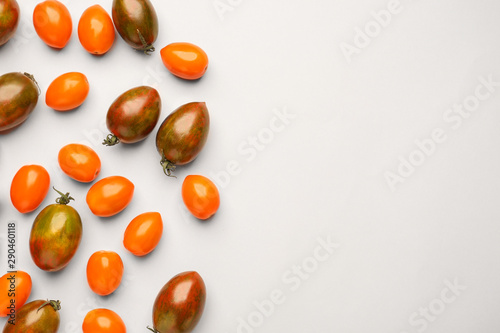 Fototapeta Naklejka Na Ścianę i Meble -  Different fresh tomatoes on light background