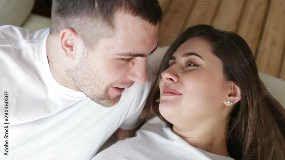 Happy young family couple laughing at home Happy young family couple laughing at home