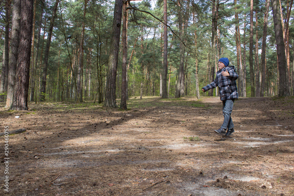 boy jumps in the forest,happy boy runs and jumps in pine forest boy jumps in the forest,happy boy runs and jumps in pine forest