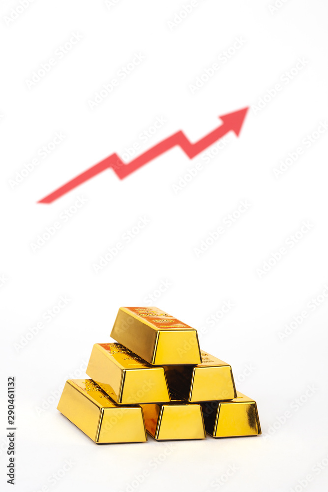 stack of gold bar with red arrow on white background stack of gold bar with red arrow on white background