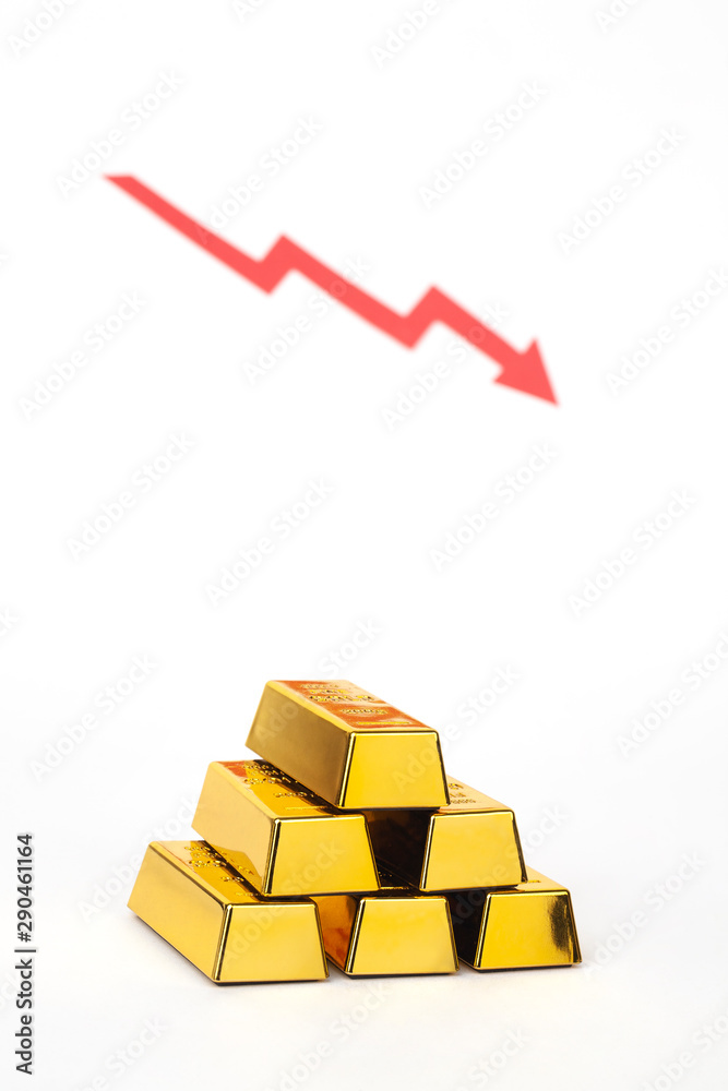 stack of gold bar with red arrow on white background stack of gold bar with red arrow on white background