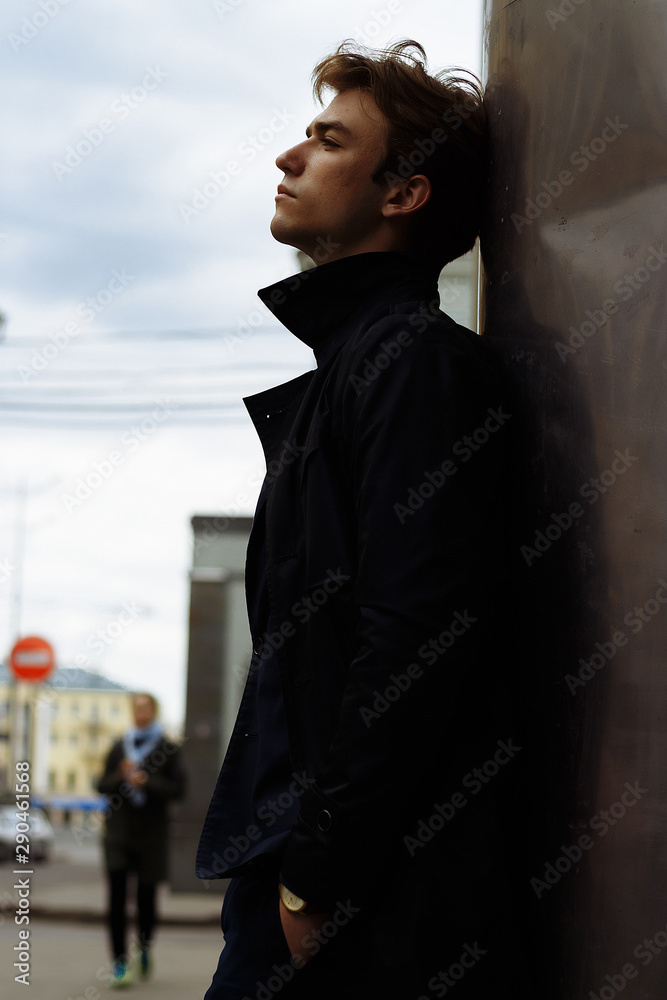 portrait of an attractive young man in a blue suit in the city portrait of an attractive young man in a blue suit in the city