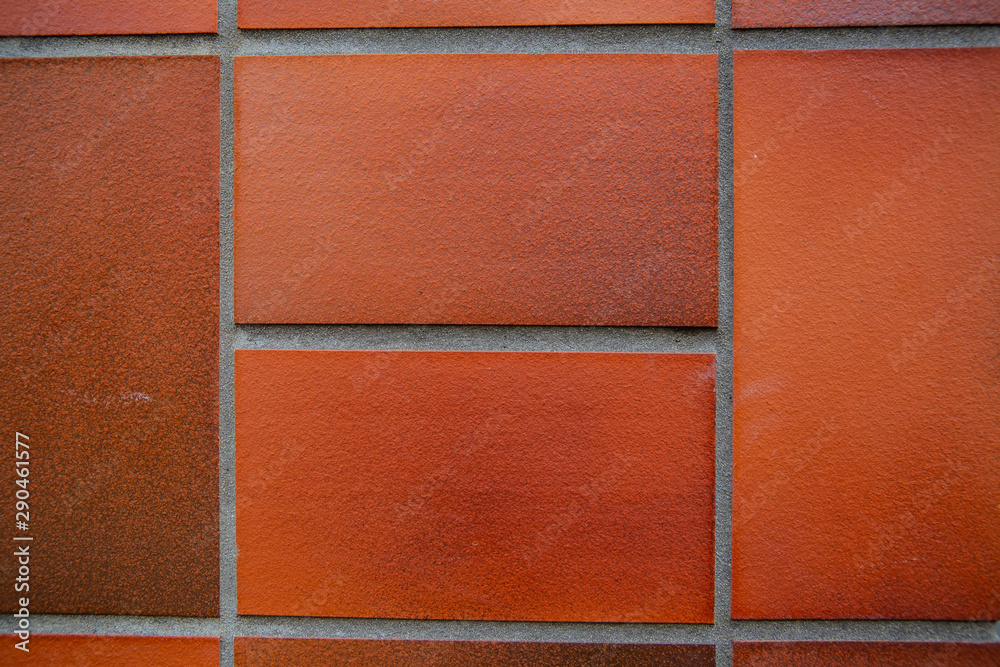 Fototapeta premium Old red brick wall. Old concrete wall. The facade of the house built of solid stone cement