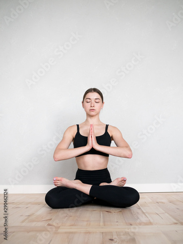 Attractive european girl doing yoga exercise