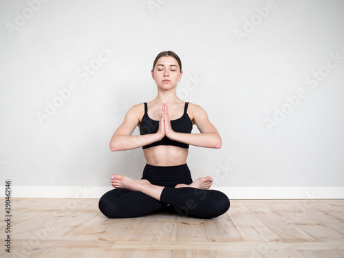 Attractive european girl doing yoga exercise