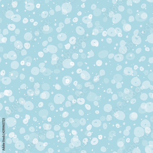 Cozy festive falling snow seamless vector pattern. Scattered transparent dots and spots on pastel blue background. Perfect for packaging, Christmas and New Years projects, cards, greetings and