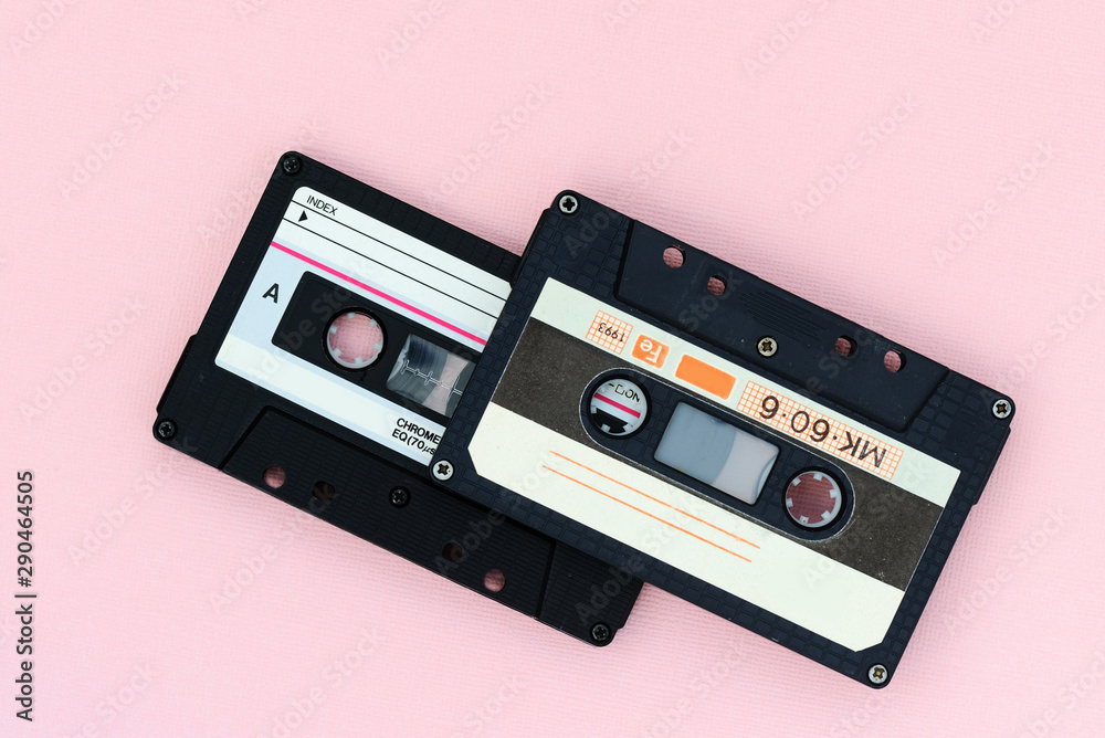 Fototapeta premium Old audio tape cassettes on a pink background. Top view, old technology concept