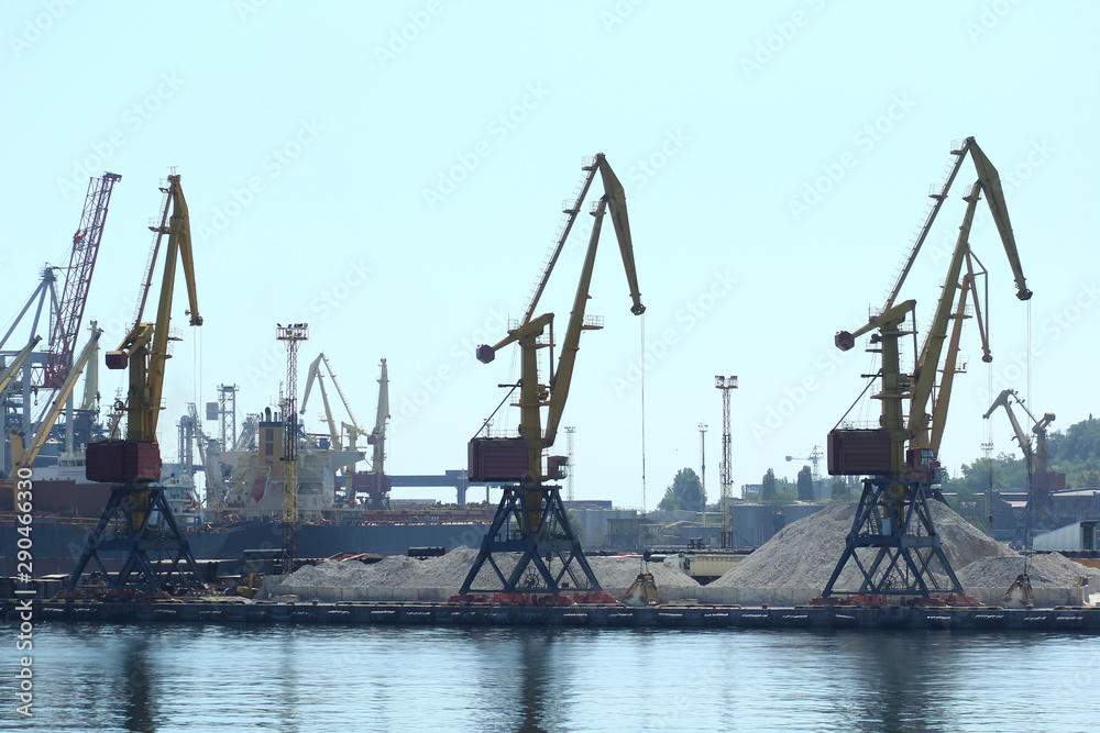 Industrial view of sea port warehouse, cranes and ships. Import export, global logistics concept.
