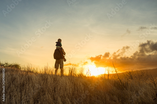 Father son on an adventure hiking through the mountain side at sunrise.  © kieferpix