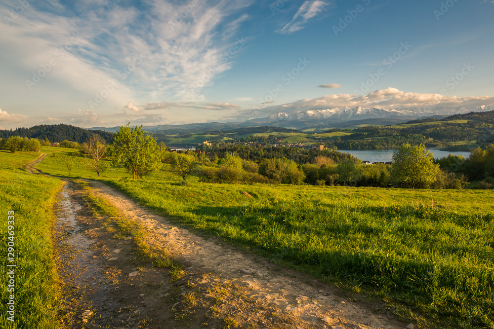 Panorama of snowy Tatra mountains and castle in Czorsztyn during spring sunset, Malopolskie, Poland