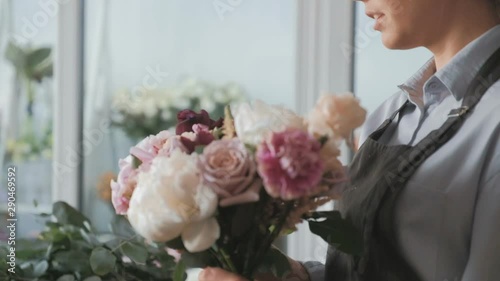 Florist making fresh flower bouquet in flower shop