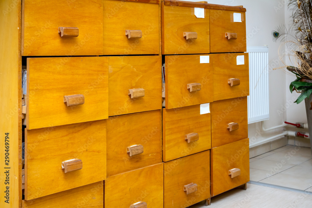 Wooden drawers with medical files of patient information in doctor's office Wooden drawers with medical files of patient information in doctor's office