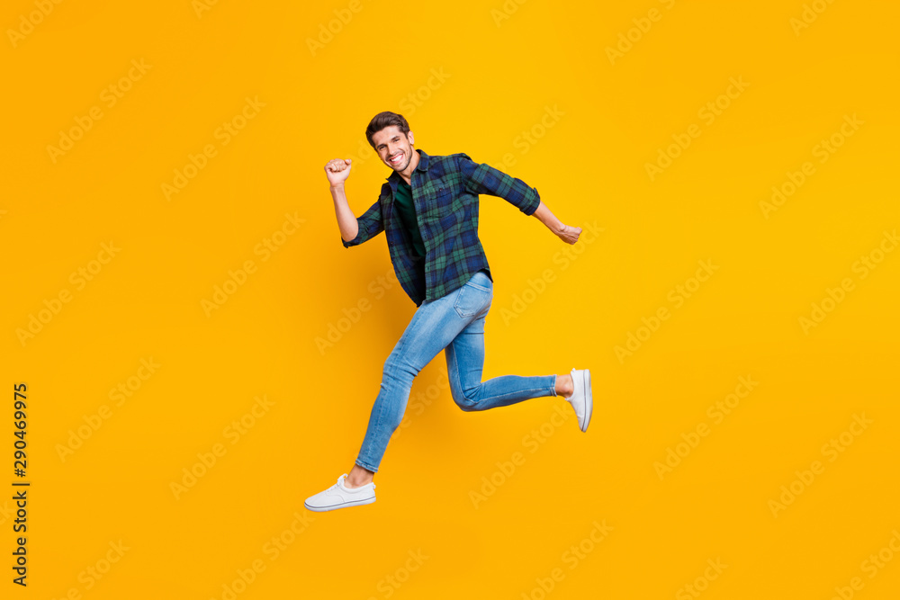 Full length body size photo of cheerful attractive handsome guy going jumping somewhere trendy wearing jeans denim isolated over vivid color background