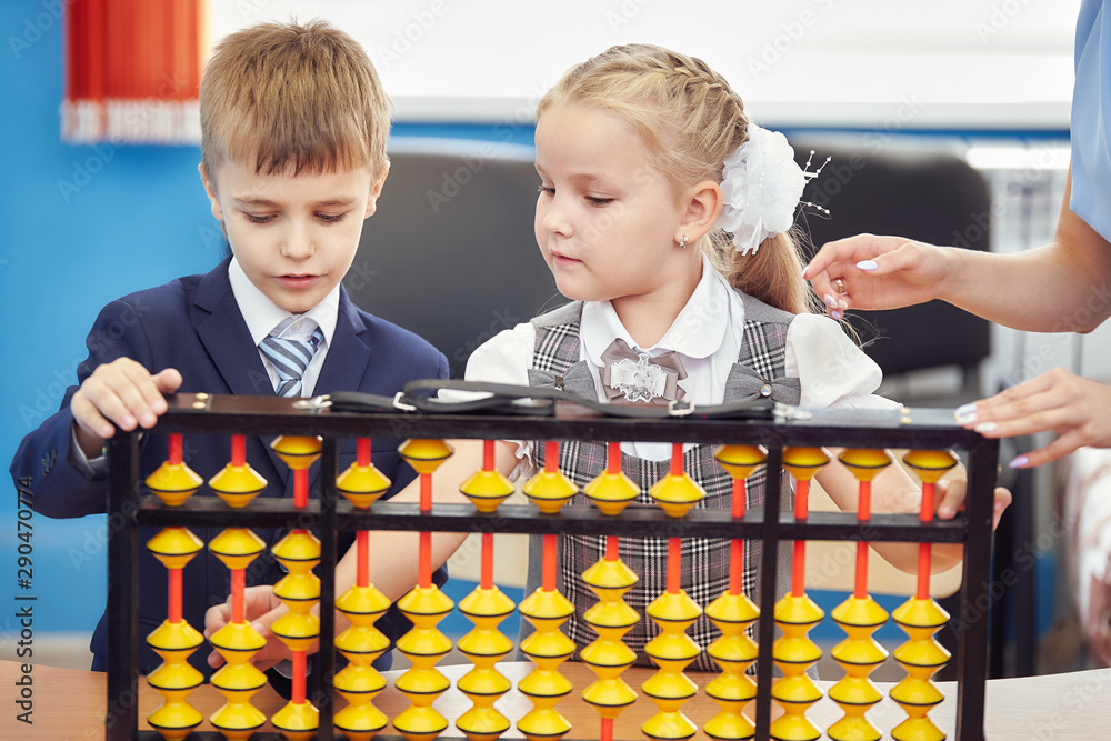 teacher teaches children mental arithmetic using large abacus soroban