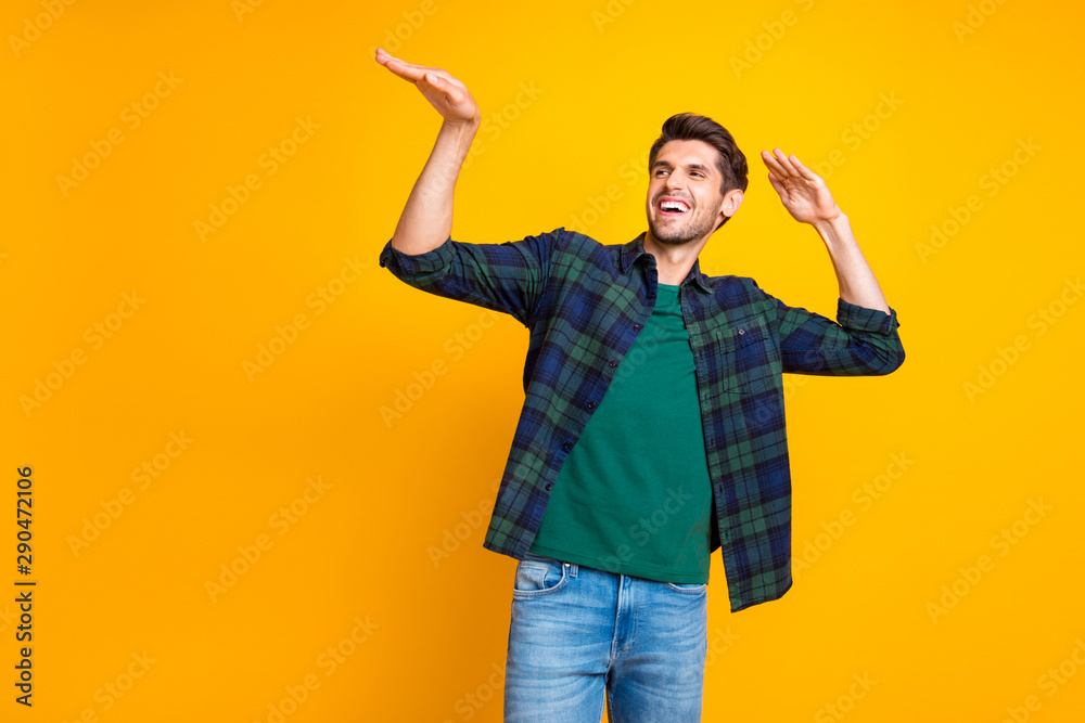 Photo of nice guy crazy dancer inviting friends to dance floor wear casual plaid shirt isolated yellow color background - obrazy, fototapety, plakaty 