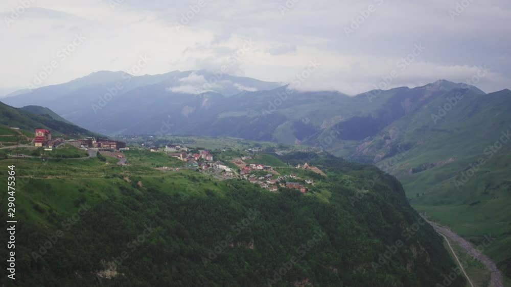 Small village on high altitude in Georgia country on cuacasian mountains at summer cloudy day - Aerial drone view Small village on high altitude in Georgia country on cuacasian mountains at summer cloudy day - Aerial drone view