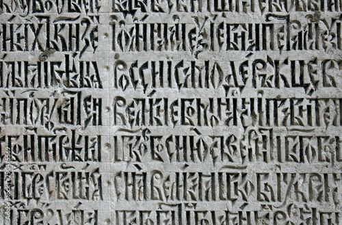 Photo of letters on a stone gray wall