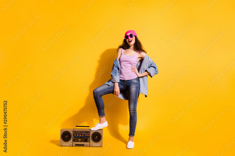 Full length photo of funky lady with big tape recorder ready for party beginning wear casual trendy clothes isolated yellow color background Full length photo of funky lady with big tape recorder ready for party beginning wear casual trendy clothes isolated yellow color background