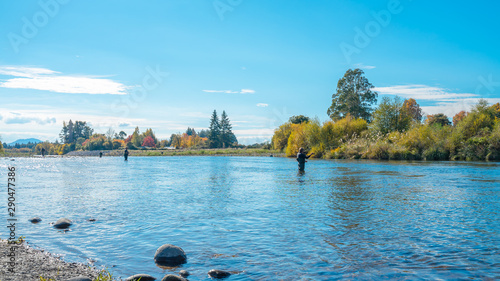Outdoor lifestyle, recreation, fly fishing technique for Trout by fisherman who fishing in Tongariro River in North Island of New Zealand.