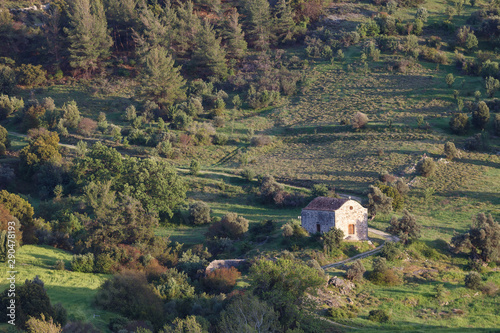 Cyprus rocky hills with agriculture, houses and small churches photo