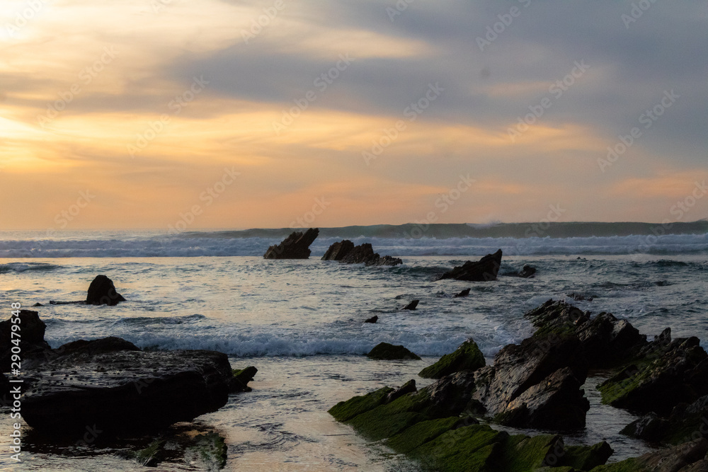 sunset at Barrika beach next to the rocks