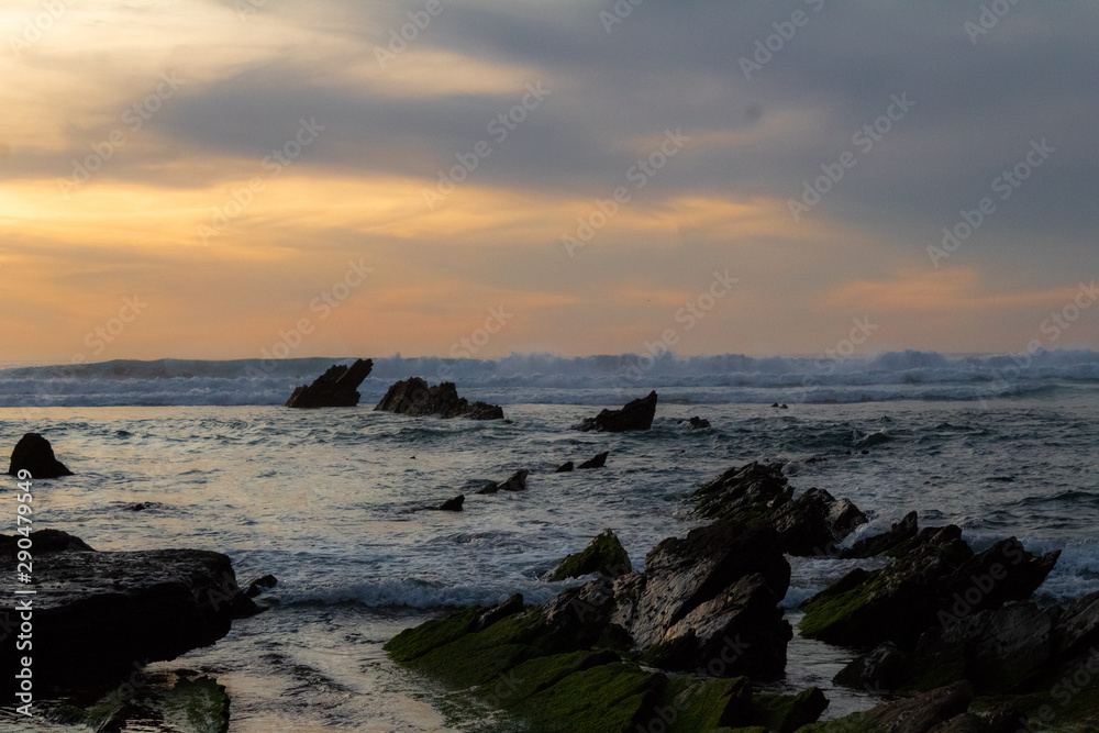 sunset at Barrika beach next to the rocks