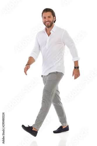 Confident Elegant Man Is Walking, Looking At Camera And Smiling © studioloco