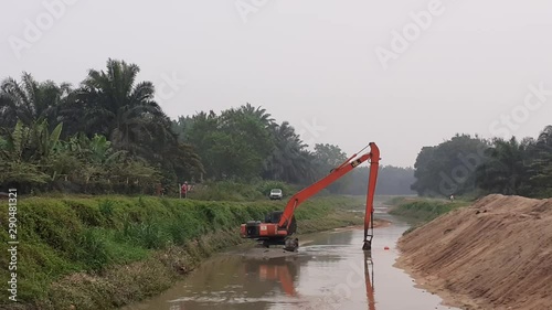 excavators doing work in a river in kluang, johor  malaysia photo