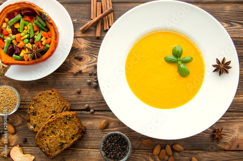 Thanksgiving dinner. Pumpkin soup, roasted pumpkin with vegetables. Traditional autumn food concept.