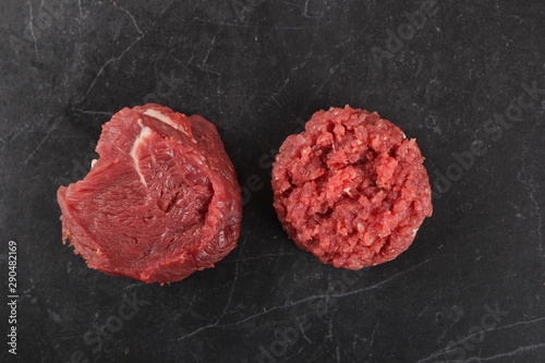 Chopped beef tenderloin. Raw meat on black stone