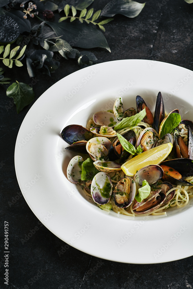Exquisite Serving White Restaurant Plate of Spaghetti Nido with Sea Shells in Wine Sauce