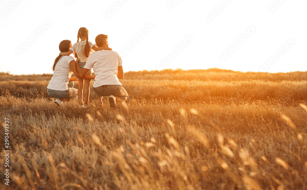 Anonymous family enjoying sunset in countryside Anonymous family enjoying sunset in countryside