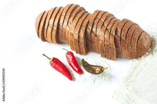 Rye bread with red chili peppers and salt on a white background isolated.