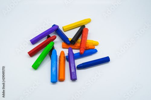 School supplies, colourful crayons stationery on white background.