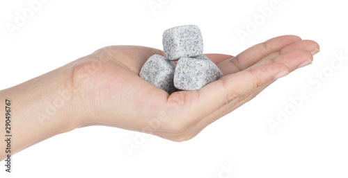 Foto Hand holding Rock soapstone ice cube isolated on white background
