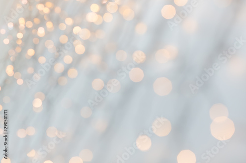 holiday, illumination and decoration concept - bokeh of christmas garland lights over grey background