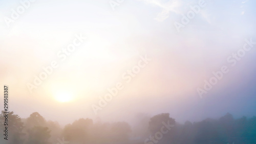 Colored sunrise in forested mountain slope with fog ,View from the mountain in the morning, Surat Thani, Thailand.