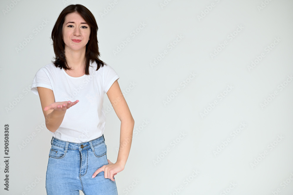 Portrait of a pretty asian brunette girl with black hair in a white t-shirt and blue jeans on a white background. It stands right in front of the camera, with emotions in various poses. Portrait of a pretty asian brunette girl with black hair in a white t-shirt and blue jeans on a white background. It stands right in front of the camera, with emotions in various poses.
