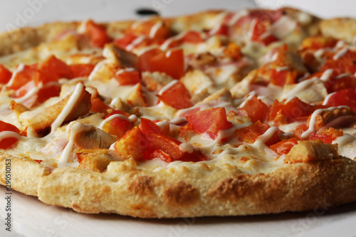 Pizza with tomato, cheese and chicken close up tasty food photo