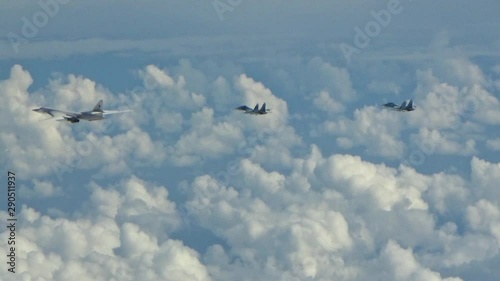 Two su-27 accompany Tu-160 in the sky