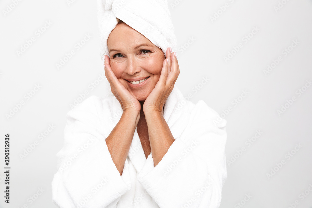 Image of feminine adult woman wearing bathrobe and towel over her head Image of feminine adult woman wearing bathrobe and towel over her head