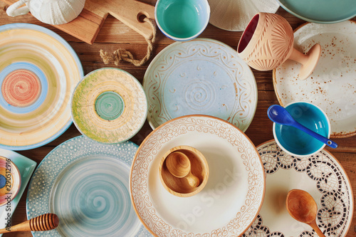 Photography Top view of assorted colorful ceramic plates and kitchen utensils