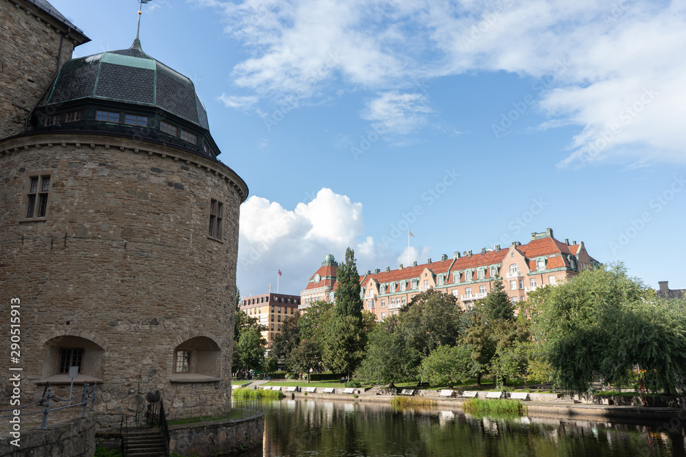 Fragment of Orebro castle with clouds and city building. Orebo town. Background or illustration. Travel photography.